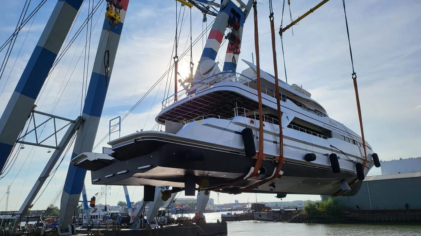 The motor yacht Brazil lifted out of the water by a floating crane during her refit