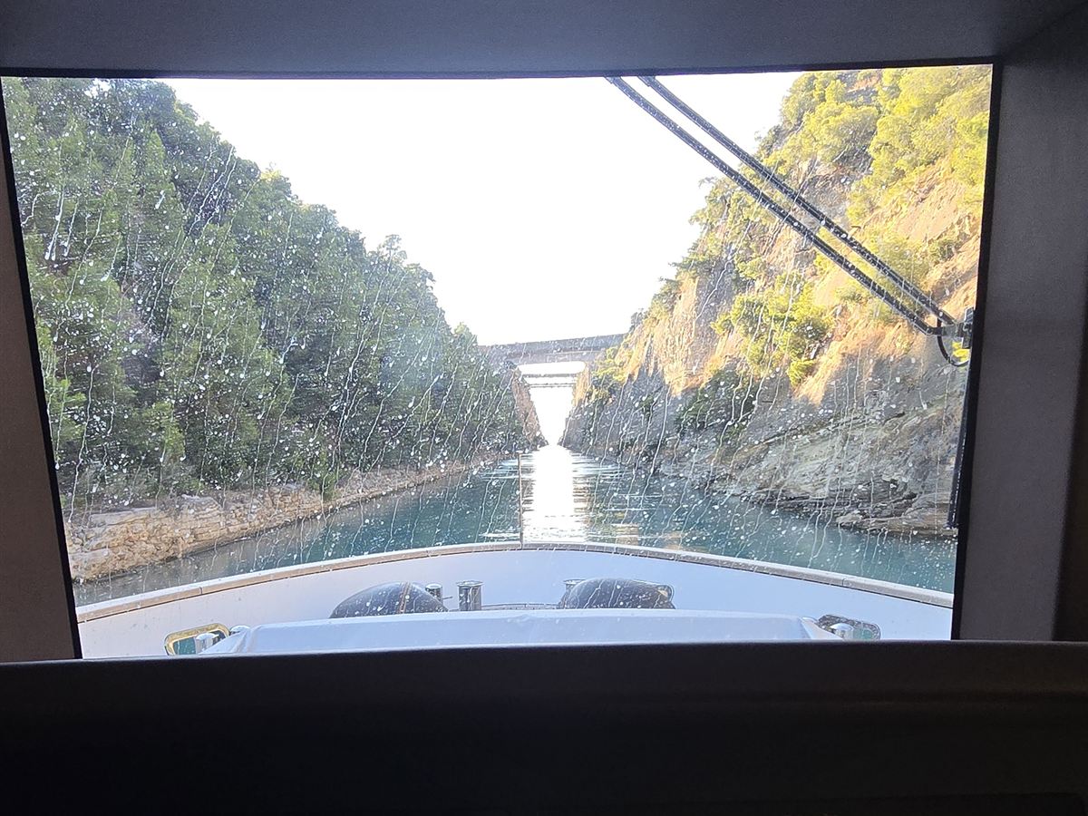 The view from a yacht wheelhouse through the Corinth Canal