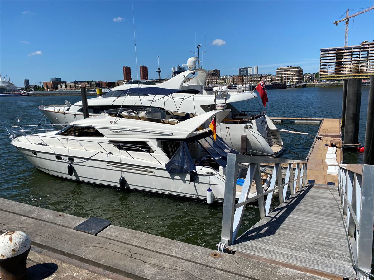A motor yacht moored in a city marina