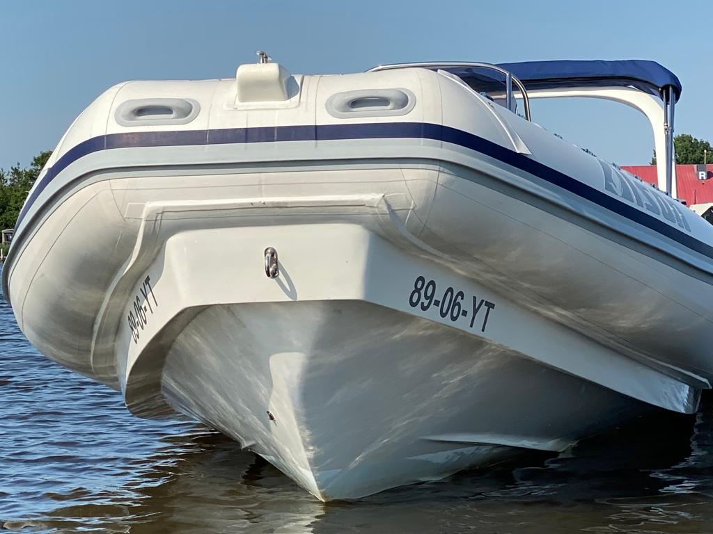A tender moored alongside a pontoon