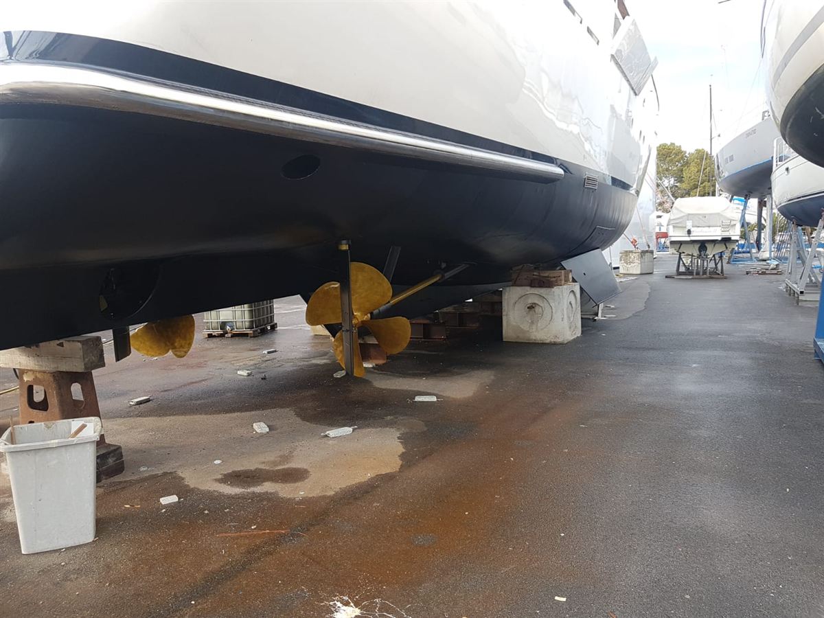 The underside of a motor yacht hull with its propellers, out of the water