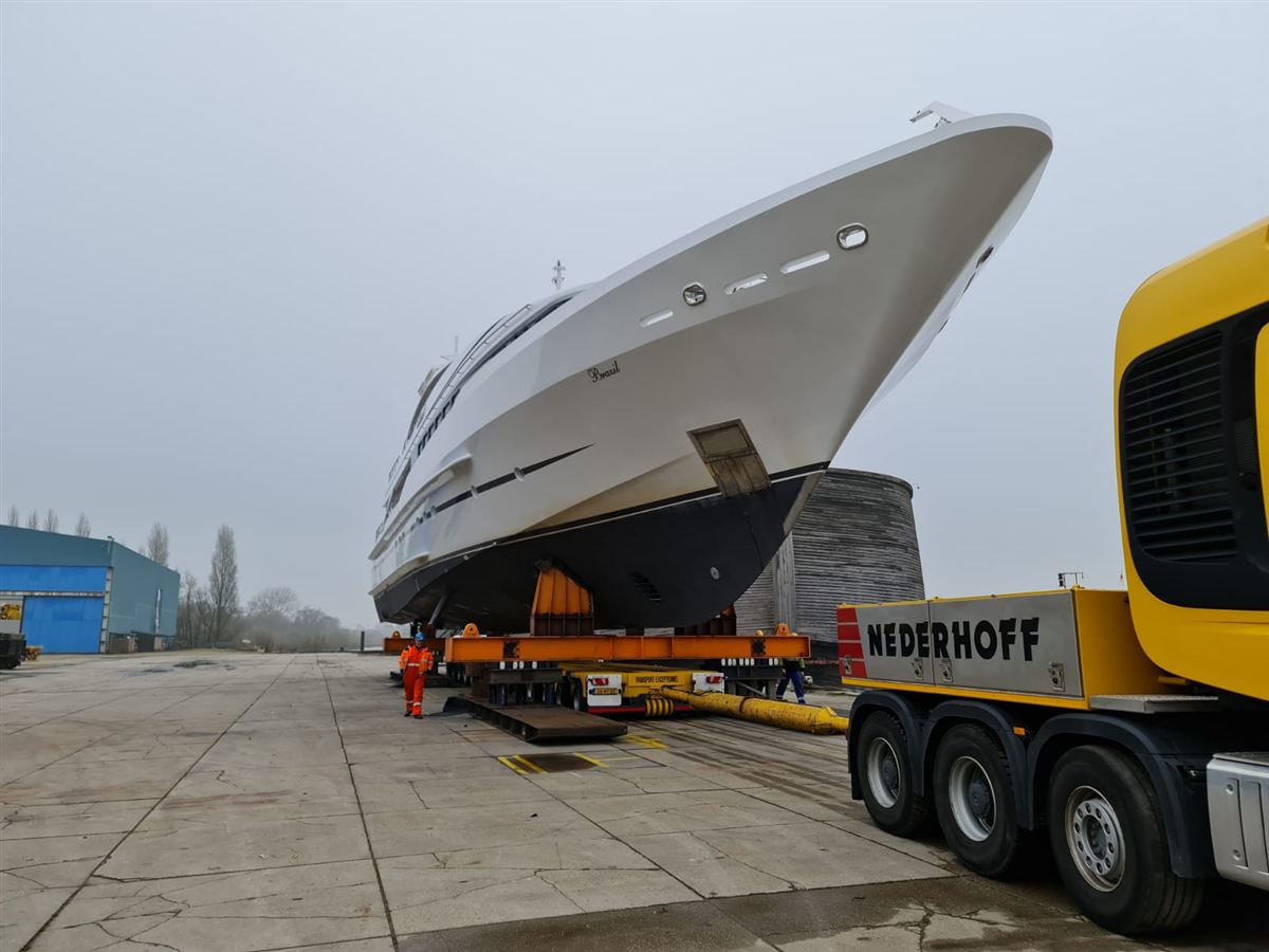 A motor yacht on a heavy-haulage trailer behind a tractor unit