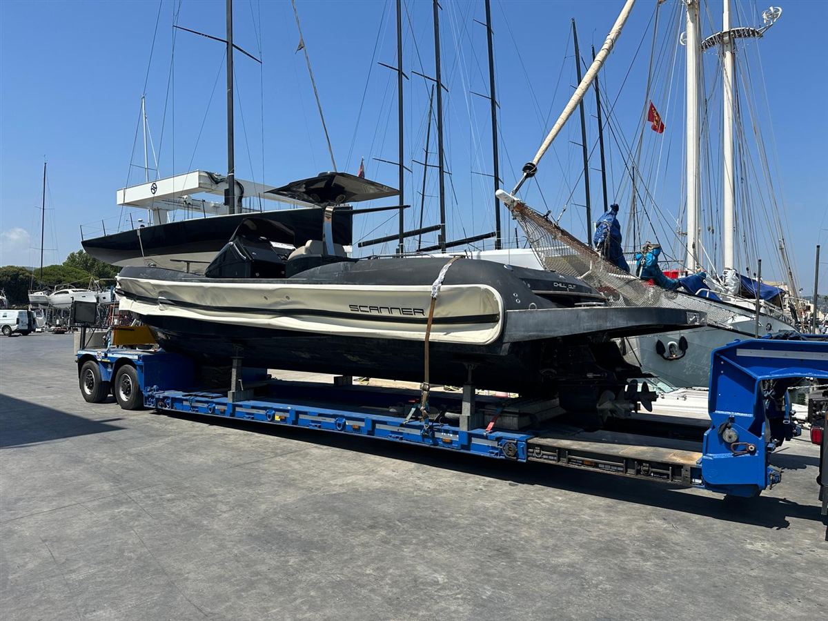 A sports boat secured on a low-loader trailer